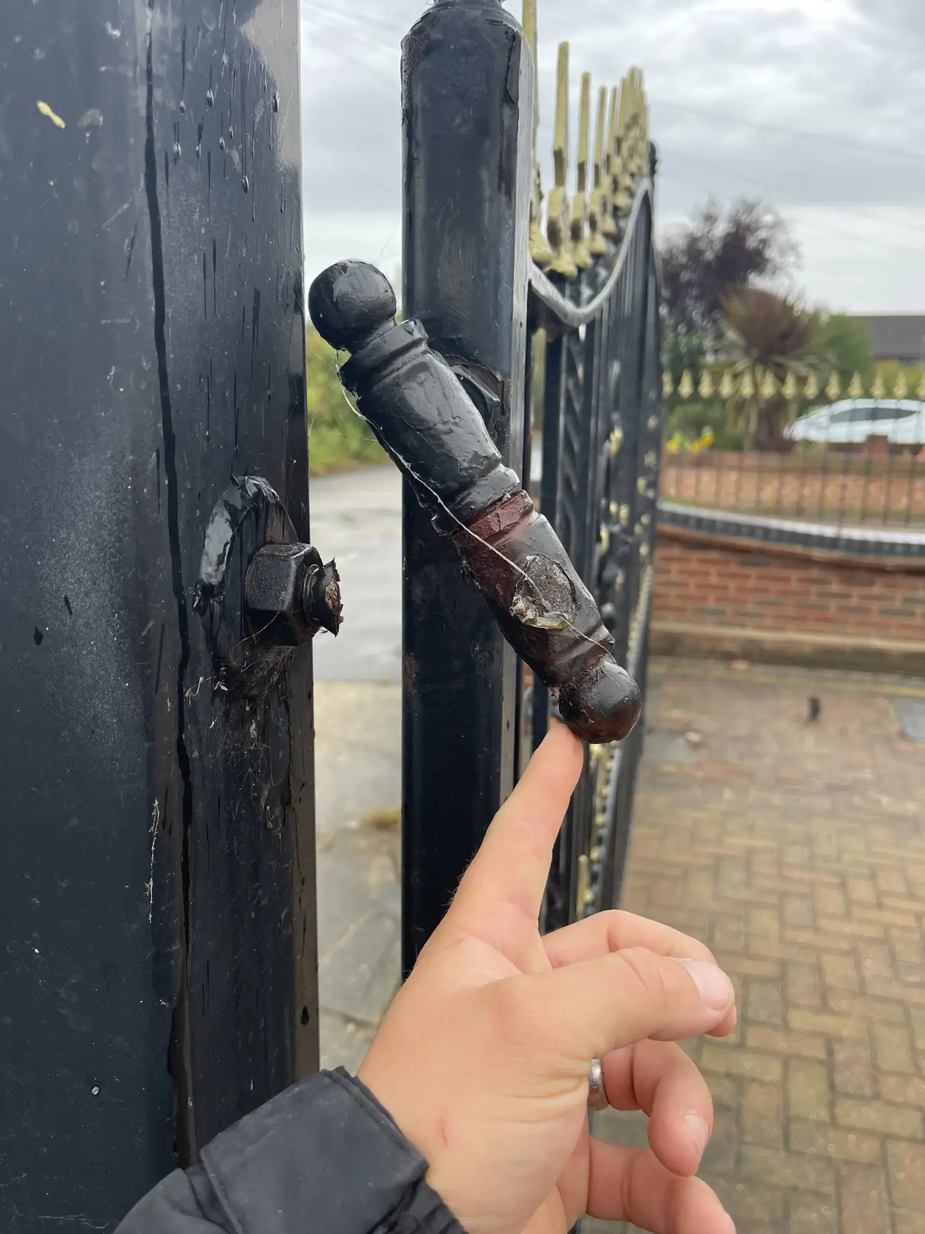 Checking a swing gate hinge during a maintenance visit