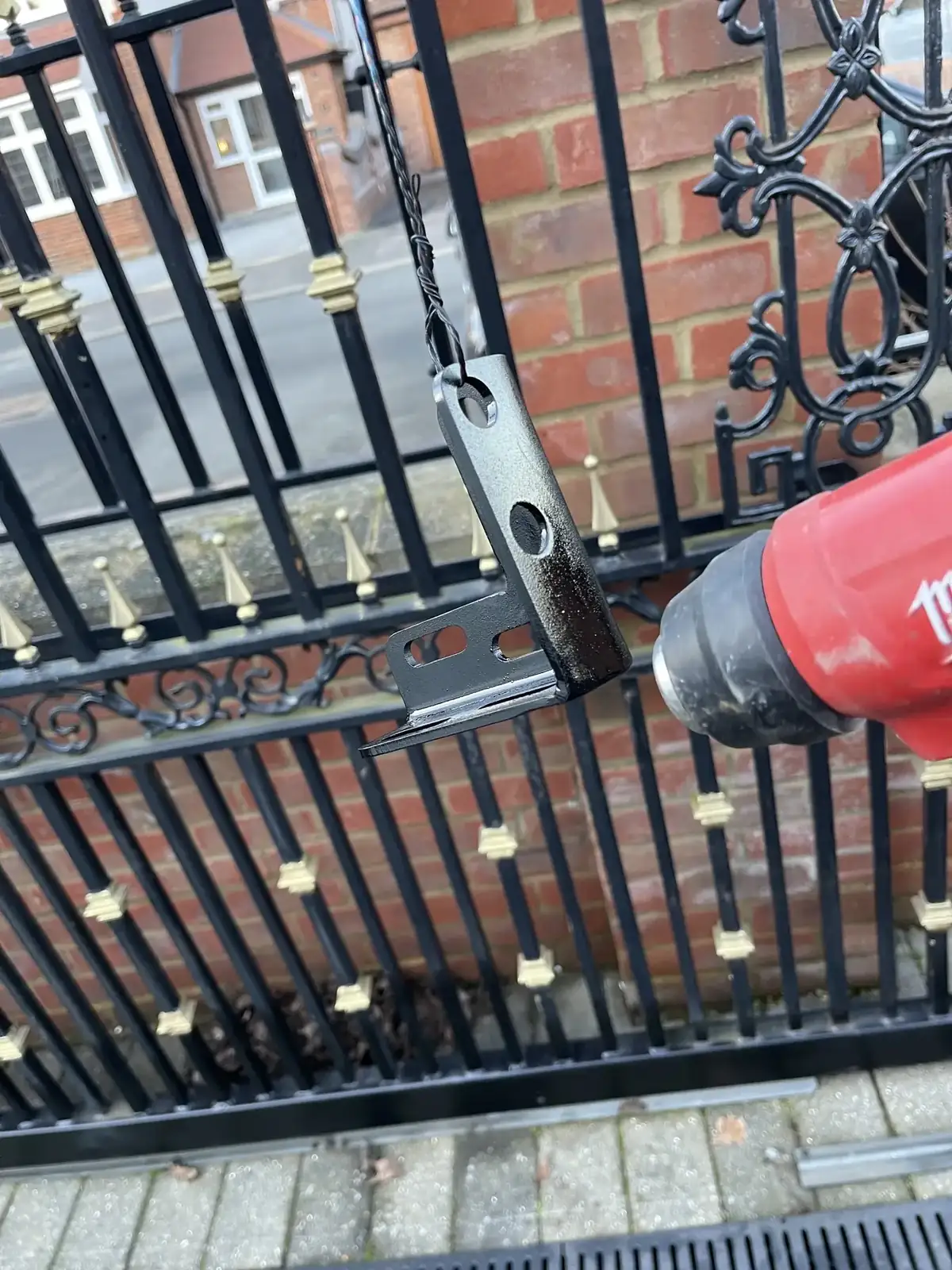 Engineer servicing an electric swing gate in Essex